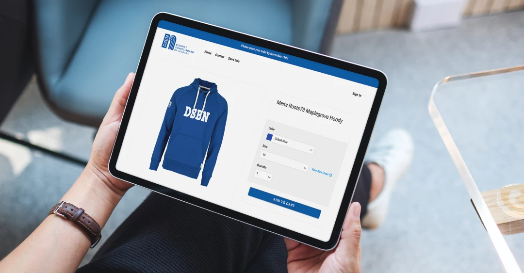 An employee of a local district school board is browsing his company's virtual pop-up shop that is full of branded merchandise, including branded Roots apparel, that he can be proud to wear and show off in his everyday life.