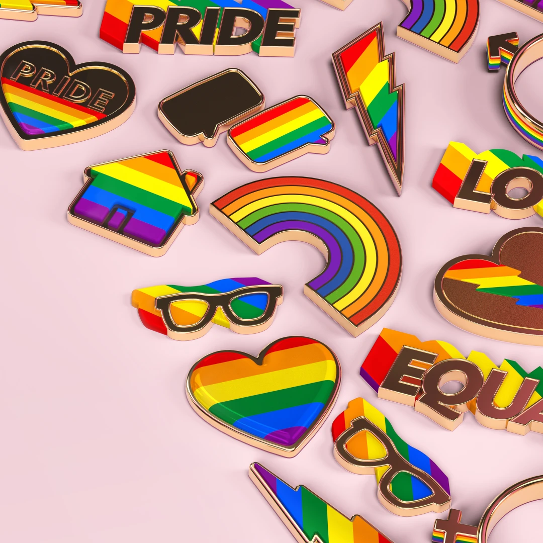 LGBTQ+ Pride rainbow branded merchandise enamel lapel pins to celebrate Pride month in the shape of rainbow, lightning bolts, hearts, glasses and houses, perfect to pin to your jacket, backpack, or work bag.