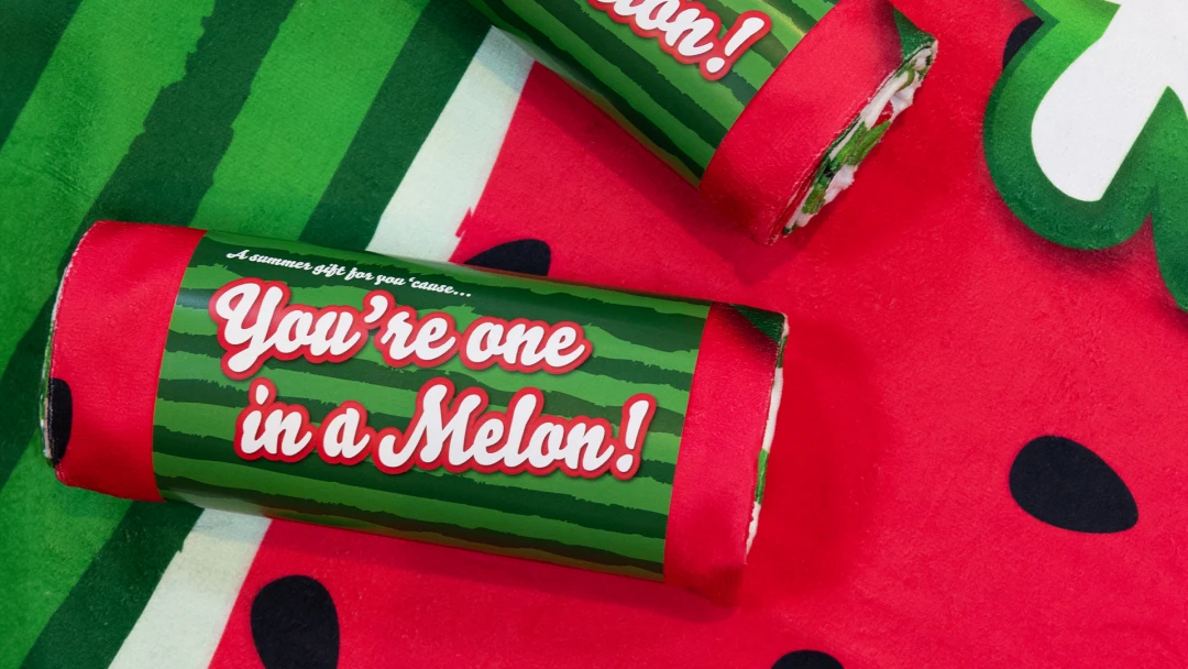 Custom sublimated towels, rolled up and encased in a custom wrap.