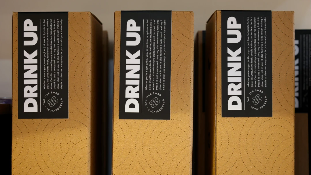 Drinkware boxes with a custom printed sticker with a marketing message.