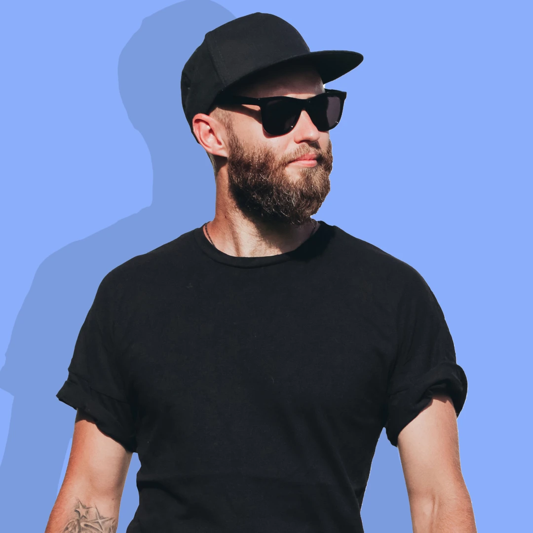 A young man wearing a Flat-Brimmed Baseball cap to match his love for style and being cool.