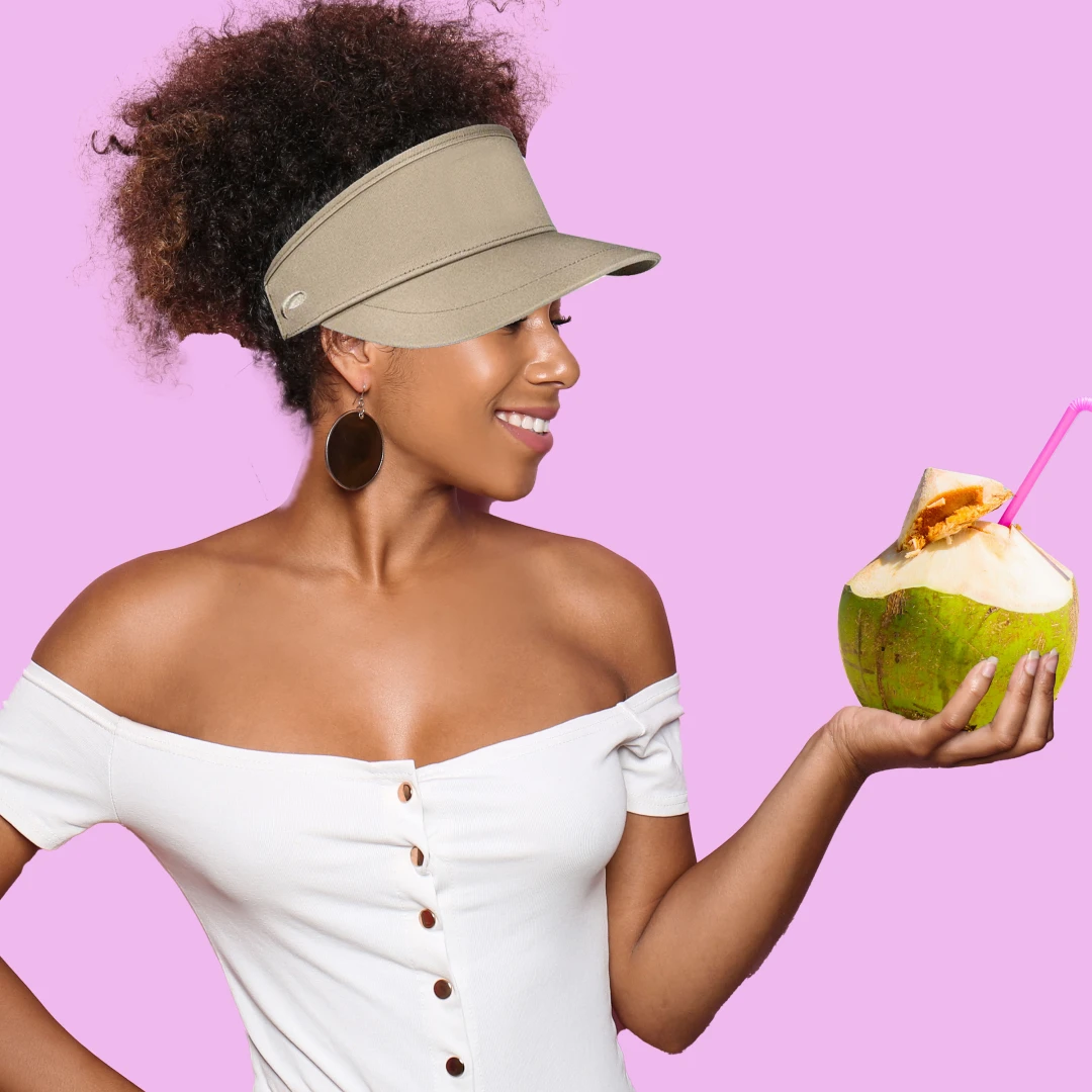 A black woman wearing a high crown visor to match her love for the finer things in life and enjoyment of summer weather. 