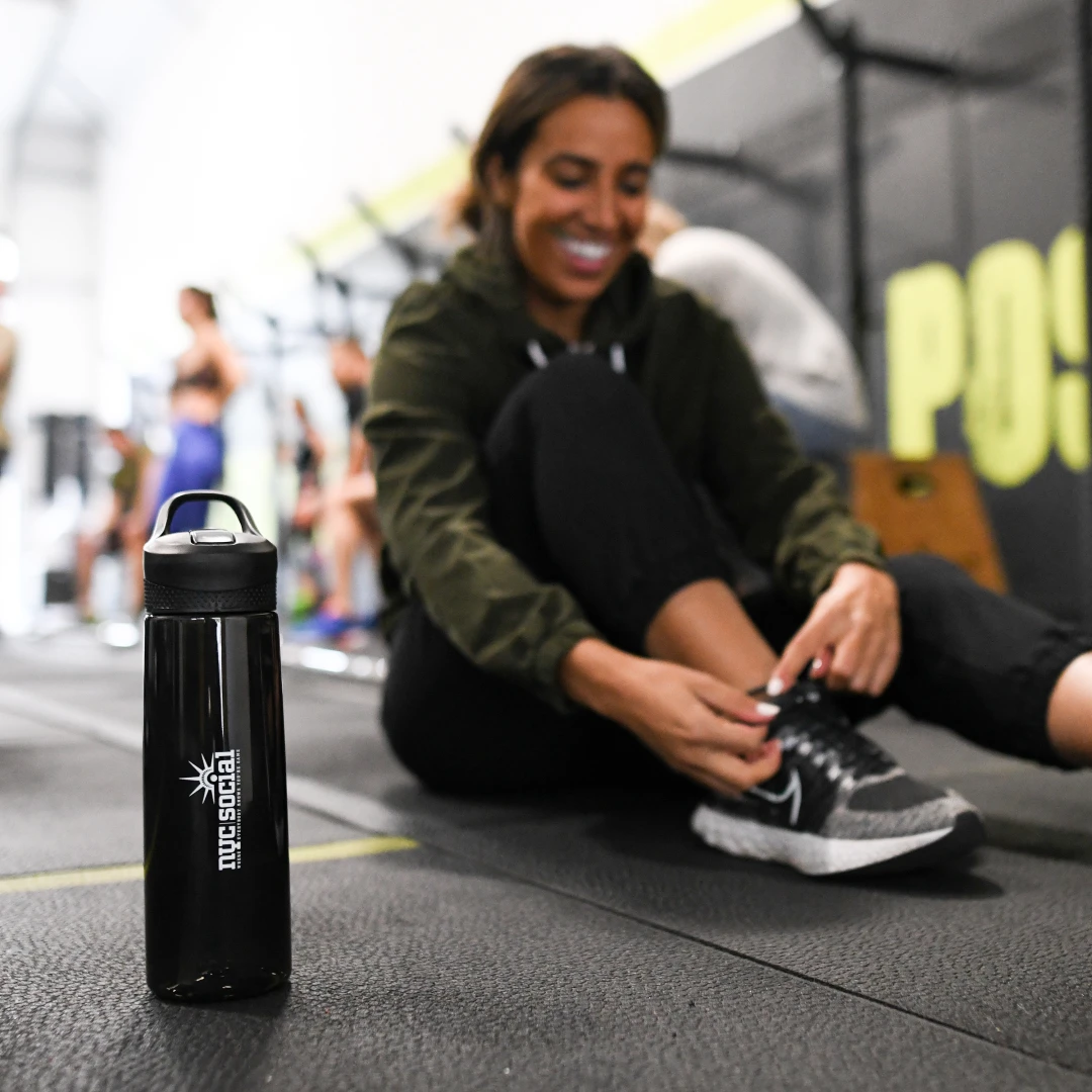 Manager participating in a fitness challenge at a gym with a company-branded water bottle from Brand Blvd.