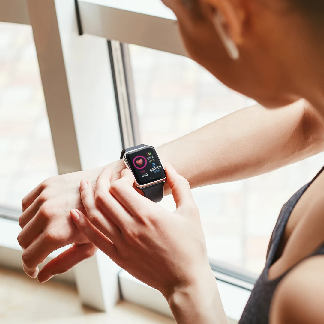 A person engaging in a company wellness challenge, featuring a custom-branded pedometer. Fostering a culture of wellness, purpose, and giving back with custom branded merch from Brand Blvd.