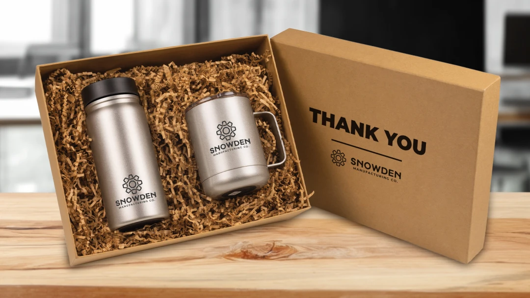 Premium drinkware mug and tumbler gift set branded with company logo in a sustainable gift box with recycled paper. Ideal branded swag for manufacturing and industrial executives as a milestone and celebration gift showcasing eco-friendly packaging.