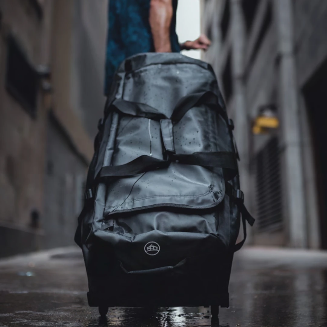 Professional using a Stormtech Trident Waterproof Rolling Duffel Bag - the ultimate branded swag for manufacturing and industrial companies. Stay prepared with practical and functional branded bags, perfect for travel.