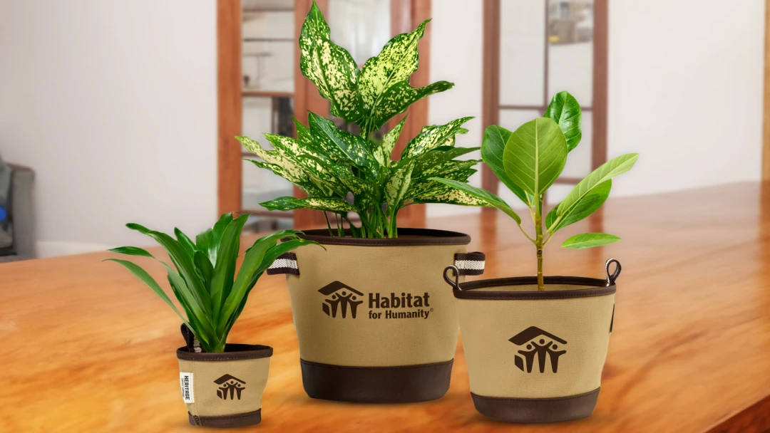 Eco-friendly plant pots featuring the Habitat for Humanity non-profit logo. An example of promotional products that make great gifts for volunteers who support their positive community impact, fundraising, and awareness.