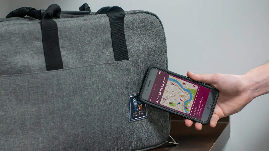 A personalized laptop bag featuring NFC Near Field Communication technology for a unique interactive brand experience. An example of thinking outside the box with branded merch ideas from Brand Blvd. 