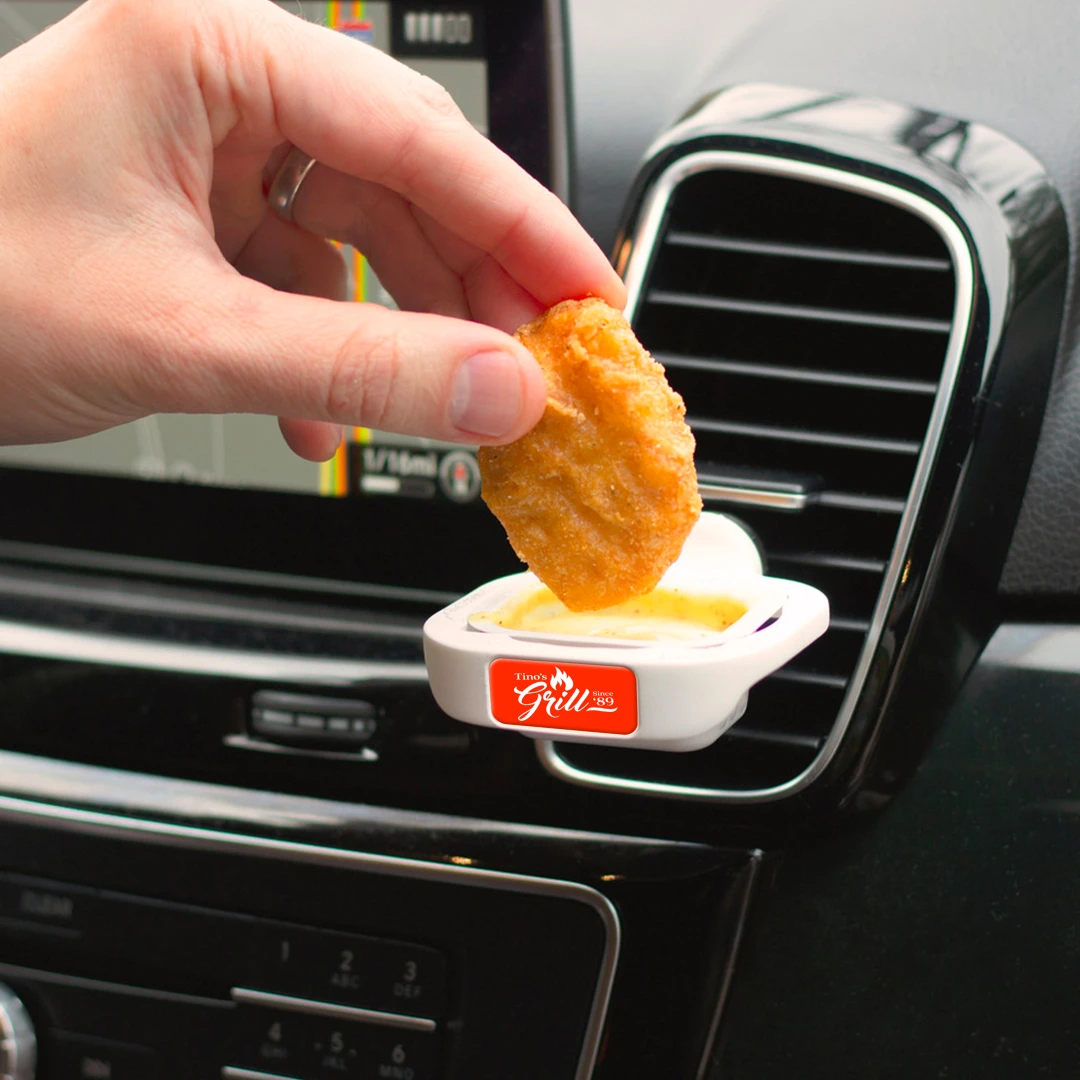 Convenient Dip Trip tray - Clip it into Your Car Vents to Hold Dipping Sauce. An example of Unique Branded Swag for Commuters. Wow Your Audience with Creative and Unusual Promotional Products that make their Drive a Delight.