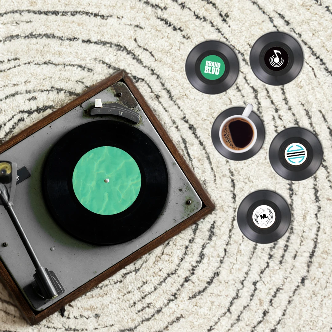 A photo of branded vinyl record coasters accompanied by a Vintage Record Player. An example of Creative, Unusual, and Wow-worthy Promotional Products and branded merch.