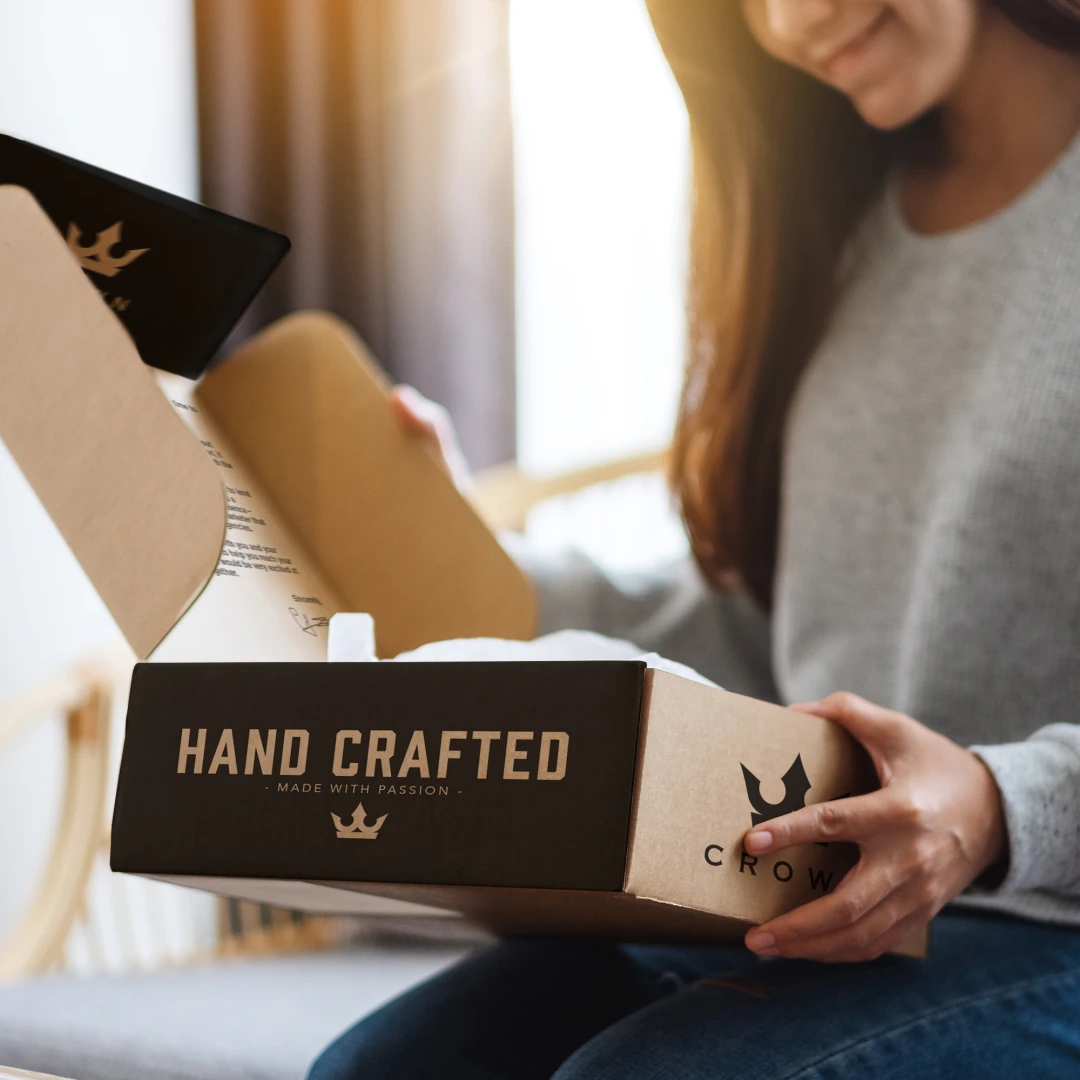 Woman smiling while un-boxing a swag kit at home.