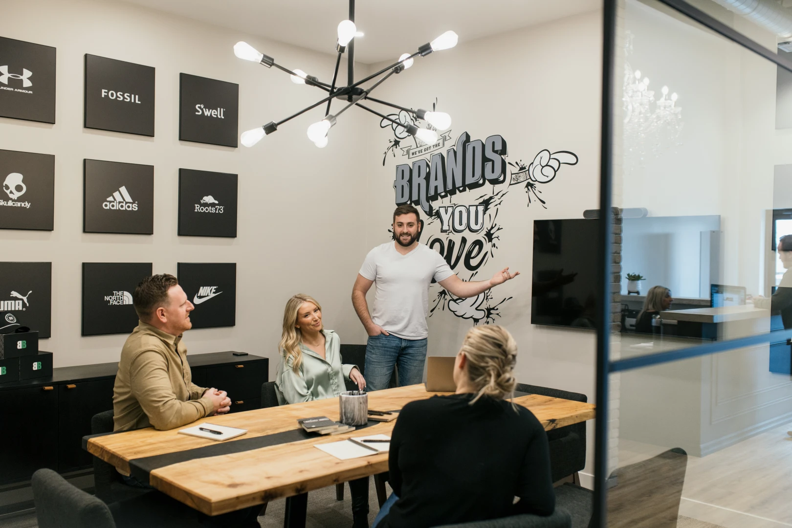 A photo of a Brand Blvd meeting room with 4 people in a meeting.