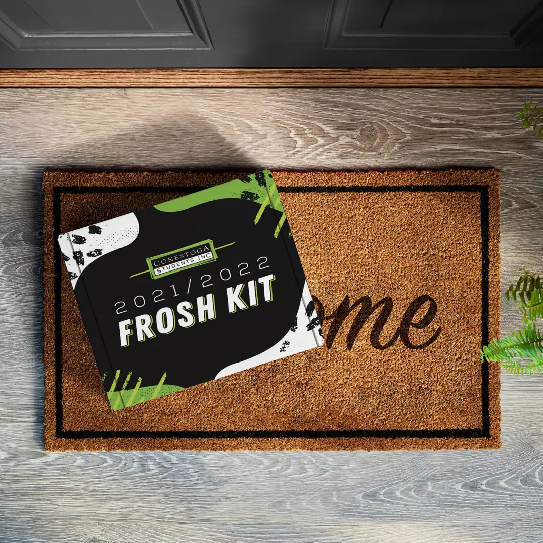 A photo of a Conestoga College Frosh swag kit. A black custom printed mailer box placed on a welcome matte.